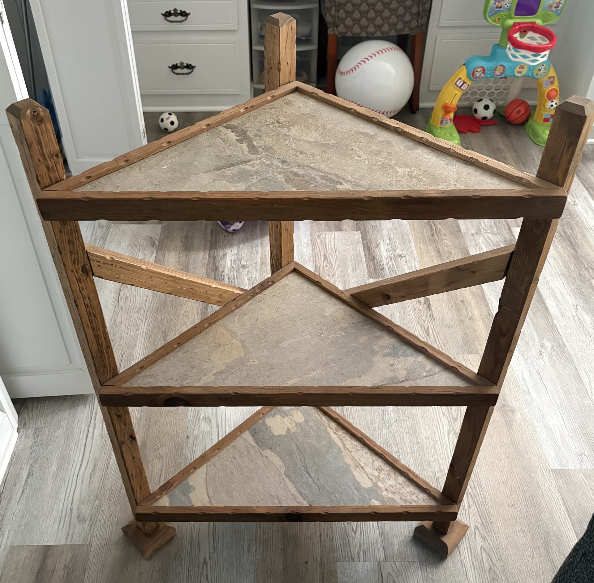 Triangular corner table with stone shelves
